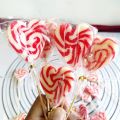 heart shaped strawberry flavored red and white swirl lollipop candy 25pc bucket. 