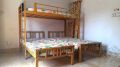 Metal Bunk Bed Frame over Two Single Wrought Iron Beds. 