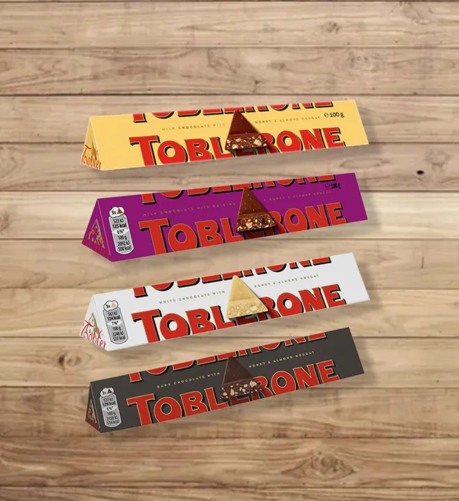 Toblerone%20Chocolate%20Bar,%20Enjoy%20Toblerone,%20The%20Iconic%20Triangular%20Chocolate%20from%20Switzerland%20(Pack%20of%204%20Milk,%20Dark,%20White,%20Fruit%20&%20Nut)%20-%20Image%202