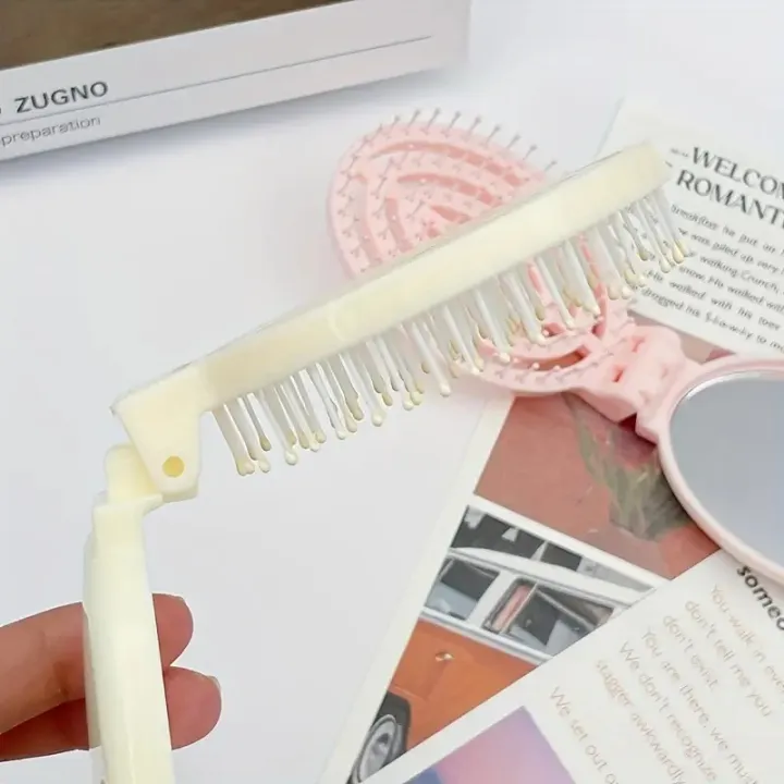 Portable%20Folding%20Hair%20Comb%20with%20Mirror,%20Lightweight%20&%20Travel-Friendly%20for%20On-the-Go%20Styling.%20A%20Perfect%20%20for%20Women%20&%20Girls.%20-%20Image%203