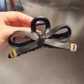 1/2 PC 2026 Y2K ladies' new street style elegant gold label black leather butterfly knot large-sized matte clutch hair accessory. 