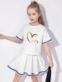 Summer girls' sporty style two-piece set with heart cartoon pattern print, pleated short skirt and short-sleeved T-shirt. 