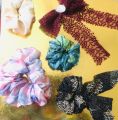 Different colours and varieties of scrunchies and bows. 