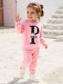 2-piece set of baby girl baby casual sports English letter printed hooded long sleeved hoodie hoodie and pants autumn and winter. 