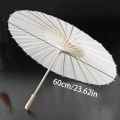 A white paper umbrella for wedding decoration - handmade traditional Chinese bridal sunshade - photo prop and party accessory.