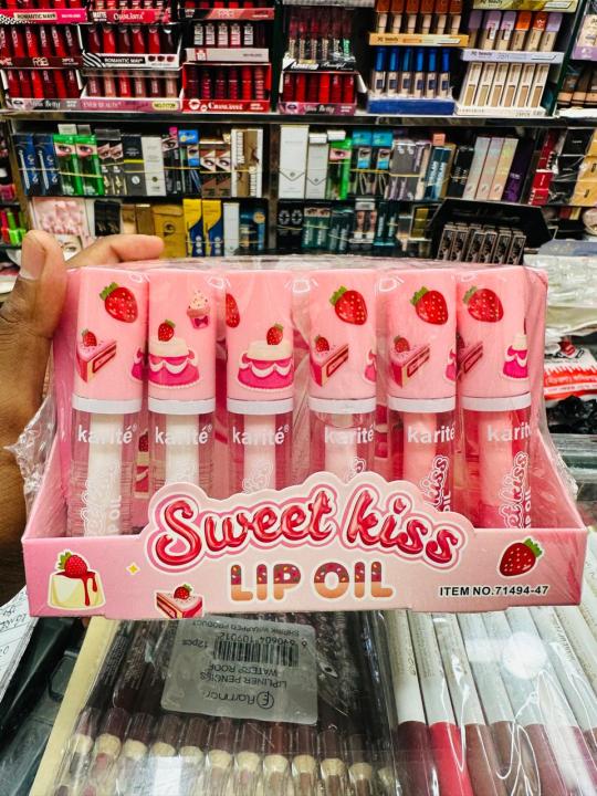 This image displays "Sweet Kiss Lip Oil" by Karité.
