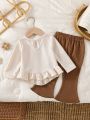 Baby girl two-piece autumn and winter printed round neck long sleeved ruffled T-shirt and elastic waisted brown bell bottom pant.