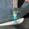 Accessories for old-style household treadle sewing machines: plastic roller presser foot and needle set.