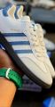 Adidas Samba OG Shoes: Classic White with Blue Stripes. 