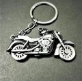 Metallic bike keychain with rotating wheels. 