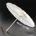 A white paper umbrella for wedding decoration - handmade traditional Chinese bridal sunshade - photo prop and party accessory.