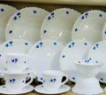 20-piece dinner set made of white opal glassware featuring a blue floral print pattern.. 