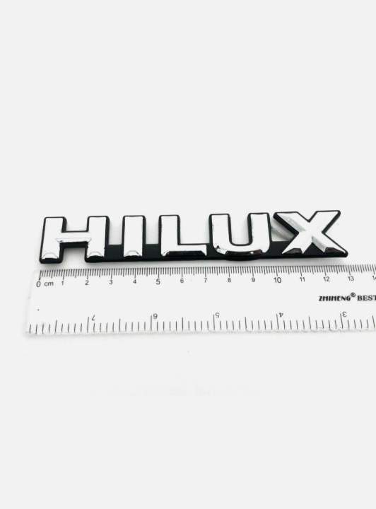 HILUX%20CHROME-BLACK%20LOGO%20EMBLEM%20BADGE%20FOR%20TOYOA%20HILUX%20LN85-106%20MIGHTY-X%20PICKUP%20-%20Image%203