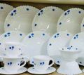 20-piece dinner set made of white opal glassware featuring a blue floral print pattern.. 