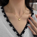 Light luxury love love titanium steel necklace women's versatile new clavicle chain plated 18K gold simple temperament peach heart necklace.