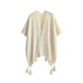 The new solid color cut-out decoration knitted ethnic shawl with furball cape and tassel in summer is a designer model.