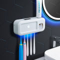Sterilize toothbrush holder ultraviolet smart wall mounted suction wall bathroom toothbrush sterilizer toothbrush hanging automatic squeeze toothpaste.
