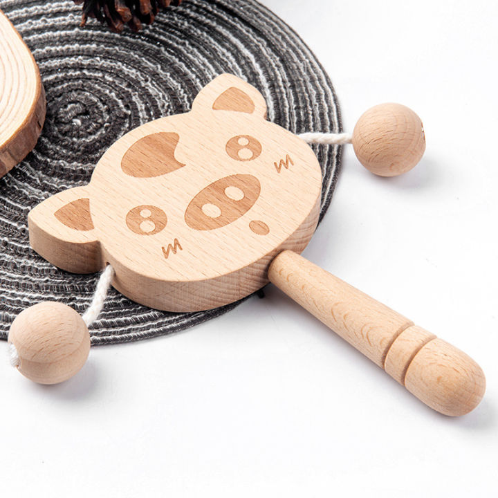 Wooden%20cartoon%20tambourine%20toy,%20newborn%20baby%20can%20chew%20and%20shake%20drum,%20traditional%20children's%20early%20education%20hand%20ringing%20the%20bell%20-%20Image%203