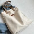 TAG Lifestyle Canvas Tote Bag/Fashionable Top Handle Off White Color With 2 Big Outside Pocket and Zipper Enclosure for girls For University/College/Trendy Fashionable Women.
