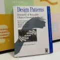 Design Patterns: Elements of Reusable Object-Oriented Software  by Erich Gamma , Richard Helm , Ralph Johnson , John Vlissides , Grady Booch (Foreword) , First Edition. 