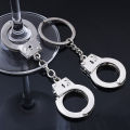 Manufacturers wholesale creative handcuff shape keychain metal small toy mini pendant car key ring gifts. 