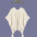 The new solid color cut-out decoration knitted ethnic shawl with furball cape and tassel in summer is a designer model.