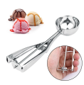 stainless steel ice cream scoop spoon with a trigger release mechanism..