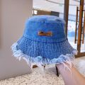 Fashionable Distressed Denim Fisherman Hat Women Washed Denim Bucket Cap with Tassel and Iron Label Outdoor Sun Protection Wide Brim.