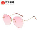 Qianai new fashion hipster cut edge sunglasses women's irregular fashion rimless ocean piece sunglasses driving mirrors.