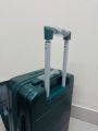 Elegant Forest Green Hard-Shell Spinner Suitcase - Lightweight ABS Carry-On Luggage with Ribbed Finish and Telescopic Handle. 