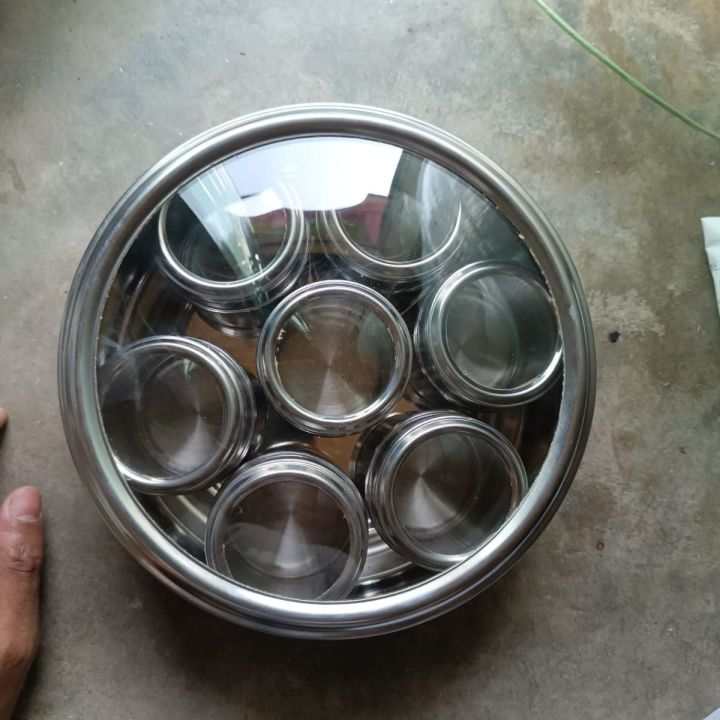 Premium 7 Pcs Stainless Steel Spice Jar Set with Rotating Carousel Stand, Durable SS Kitchen Spice Rack with Glass Lids, Ideal for Organizing Spices, Herbs, and Seasonings in Your Modern Pantry System.