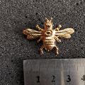 Golden bee brooch pin buckle for men women outfit fashion accessories.