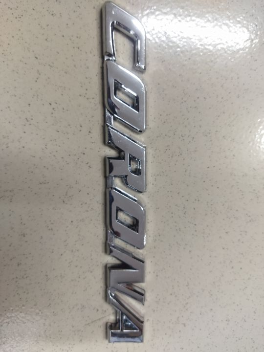 CORONA"%20chrome%20emblem,%20likely%20for%20a%20car.%20This%20is%20a%20car%20monogram%20or%20badge,%20commonly%20used%20on%20Toyota%20Corona%20vehicles.%20-%20Image%202
