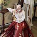 New Chinese style Hanfu heavy industry embroidery, cloud shoulder standing collar shirt, paired with woven gold horse face skirt, wedding engagement dress. 