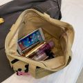 Simple Versatile Canvas Handbag Personalized Letter Printed Shoulder Bag Fashionable Large Capacity Commuter Tote Bag. 