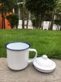 rust free good 370ml unbreakable nostalgic cookable heatable enamel tea mug with lid blue rim on mug and lid.