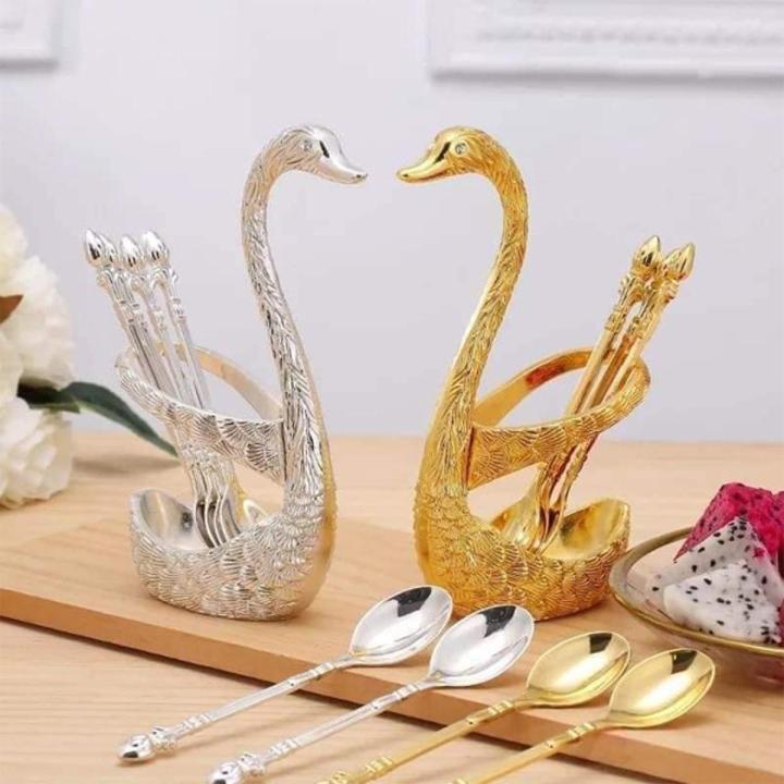 Gold spoon holder in the shape of a duck with a set of 6 fancy spoons