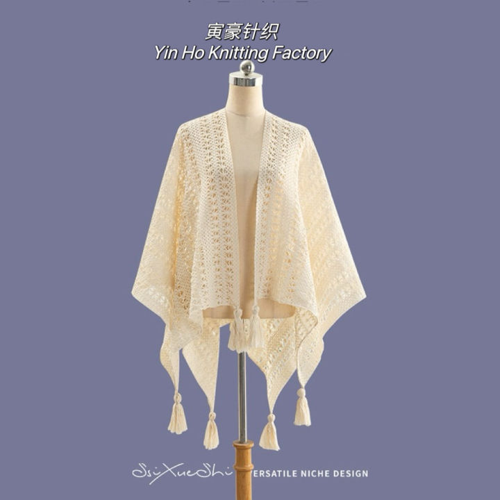 The new solid color cut-out decoration knitted ethnic shawl with furball cape and tassel in summer is a designer model