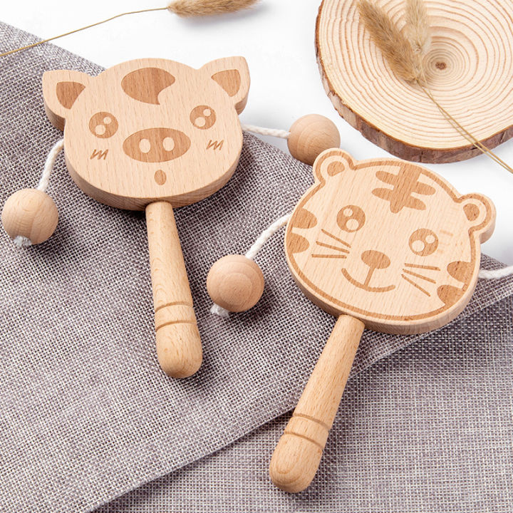 Wooden%20cartoon%20tambourine%20toy,%20newborn%20baby%20can%20chew%20and%20shake%20drum,%20traditional%20children's%20early%20education%20hand%20ringing%20the%20bell%20-%20Image%202