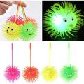 Smile Face Puffer Ball with Flashing Light Stress Relief Squeeze Ball Fun Toy for Children and Adults (Random Color) Pack of 1.