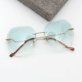 Qianai new fashion hipster cut edge sunglasses women's irregular fashion rimless ocean piece sunglasses driving mirrors.