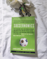 Soccernomics by Simon Kuper and Stefan Szymanski. 