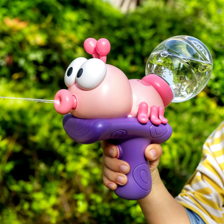 Pink ant-shaped electric water blaster spraying outdoors
