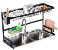 Double sink stainless steel dish drying rack over sink with cutlery holder. 