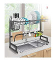 Double sink stainless steel dish drying rack over sink with cutlery holder. 