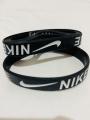 Nike Embossed Black Rubber Band. 