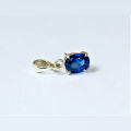 silver jewel with a blue gem. 