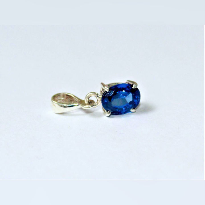 silver jewel with a blue gem