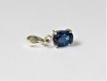 silver jewel with a blue gem. 