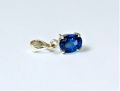 silver jewel with a blue gem. 